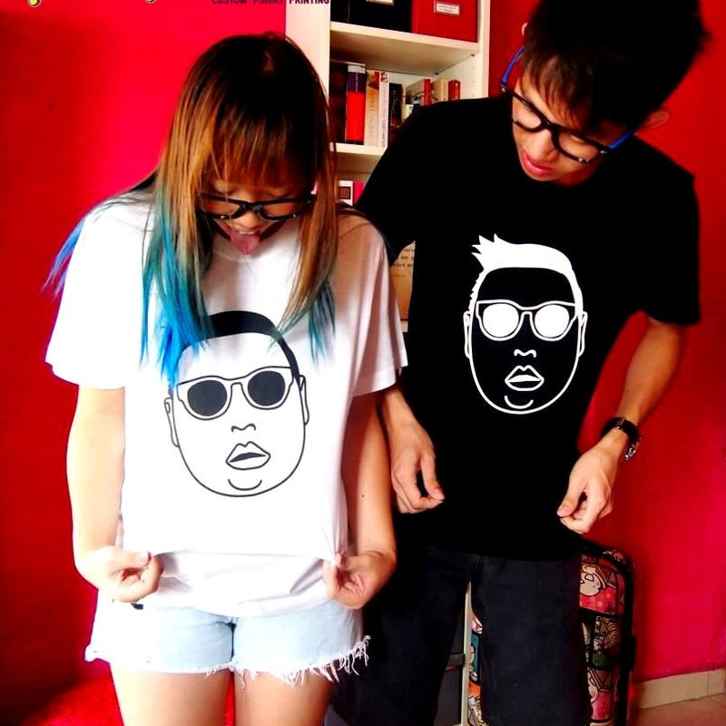 Two people wearing tees printed with their own faces
